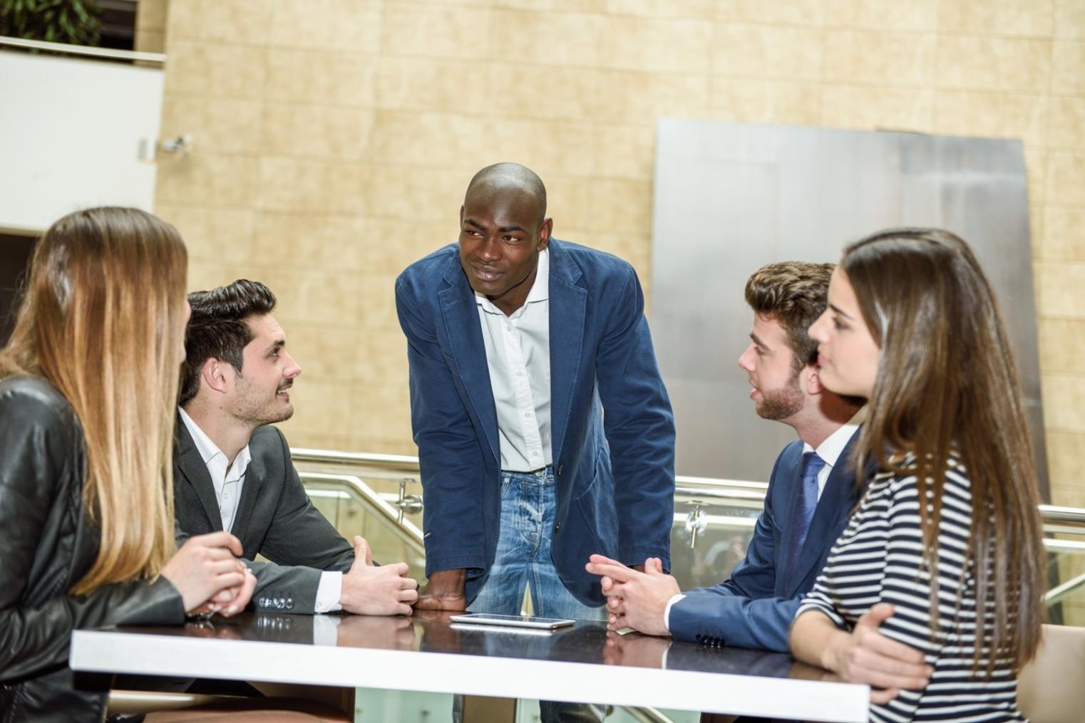 Interactive workshop setting with participants reviewing financial planning materials and business strategies